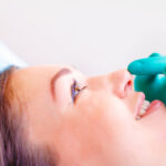 Doctor prepares woman's nose for rhinoplasty surgery